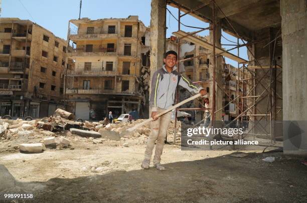 Syrian boy helping with a building's reconstruction in the Syrian city of Aleppo, Syria, 24 June 2017. Large swathes of the city, mostly in eastern...