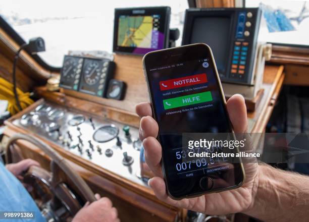 An illustration picture dated 08 August 2017 showing the new security app of the German Maritime Search and Rescue Service aboard a motorboat in the...