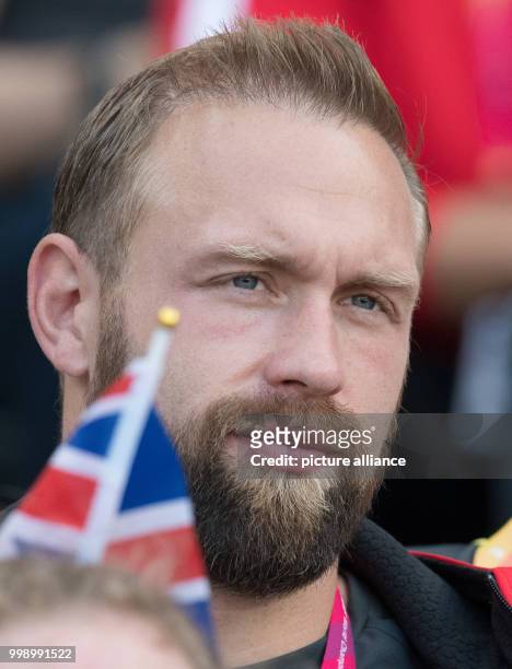 German discus thrower Robert Harting following the women's discus throw qualifier and watching the throw by his wife, Julia Harting, at the IAAF...