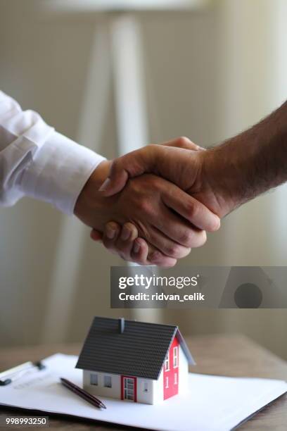 handshakes with customer after contract signature - signing mortgage stock pictures, royalty-free photos & images