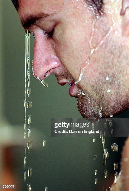 Clark Keating of the Brisbane Lions cools off under the shower after the Lions recovery training session at the Gabba in Brisbane, Australia. The...