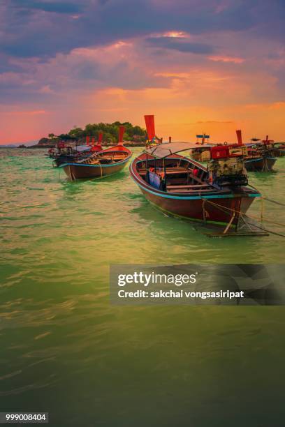 scenic view of longtail boats on the beach against sky during sunrise, koh lipe, thailand - longtail boat stock pictures, royalty-free photos & images