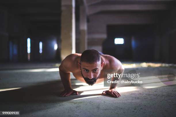 strong young man exercises push-ups - biological process stock pictures, royalty-free photos & images