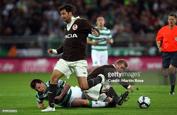 Jonathan Bourgault of St. Pauli and Paul McGowan of Celtic battle for the ball during the friendly match between FC St. Pauli and Celtic at the...