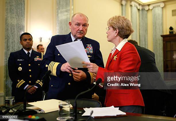 Coast Guard Commandant Admiral Thad Allen discusses with National Oceanic and Atmospheric Administration Administrator Jane Lubchenco prior to a...