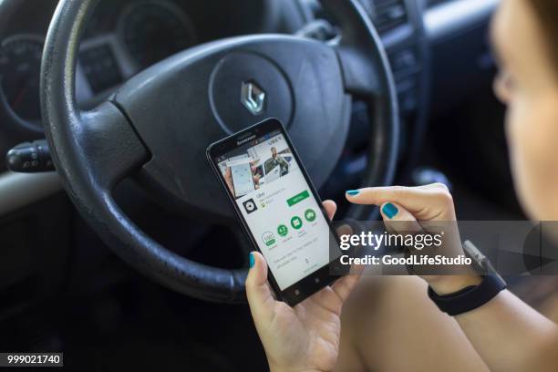 installing the uber app - sharing economy stock pictures, royalty-free photos & images
