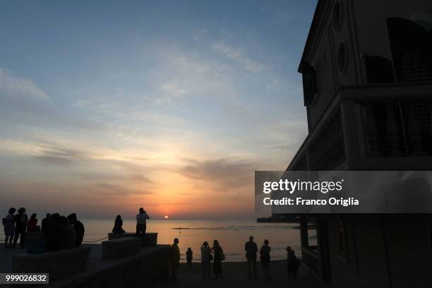 Tourists at the sunset visit Montalbano's house and his beach, in the fictional 'Marinella', on June 04, 2018 in Punta Secca, Ragusa, Italy....