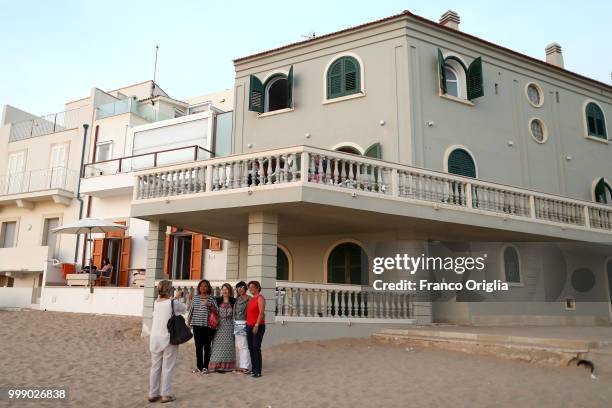 Tourists take picture in front Montalbano's house, in the fictional 'Marinella', on June 04, 2018 in Punta Secca, Ragusa, Italy. Inspector Salvo...
