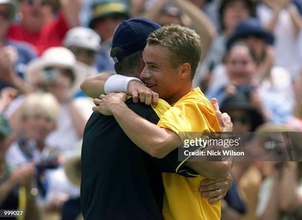 Lleyton Hewitt of Australia celebrates his 7/6, 5/7,6/2,6/1 win over Thomas Johansson of Sweden and hugs his captain John Fitzgerald during the third...