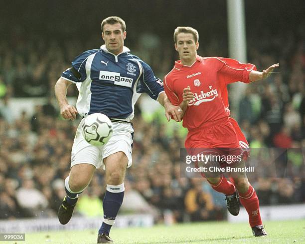 Michael Owen of Liverpool challenges David Unsworth of Everton during the FA Barclaycard Premiership match between Everton and Liverpool at Goodison...