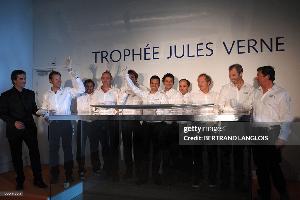 French skipper Franck Cammas (C) and his