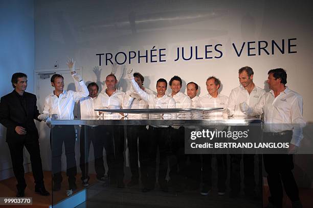 French skipper Franck Cammas and his teammates pose behind the Jules Verne Trophy, on May 18, 2010 during the award ceremony held at the National...