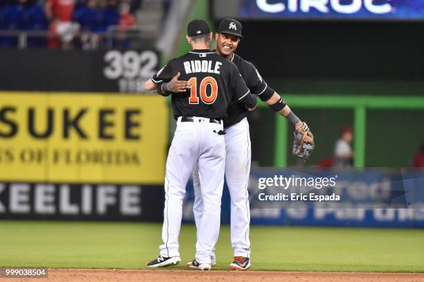 Starlin Castro of the Miami Marlins hugs JT Riddle after defeating the Philadelphia Phillies at Marlins Park on July 14, 2018 in Miami, Florida.