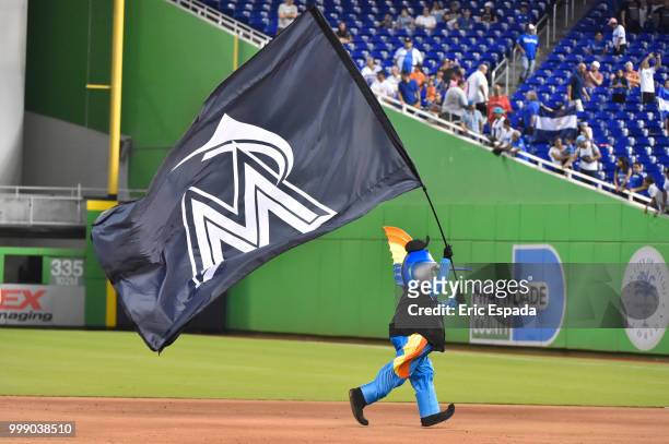 Billy the Marlin runs with a flag after the Miami Marlins defeated the Philadelphia Phillies at Marlins Park on July 14, 2018 in Miami, Florida.