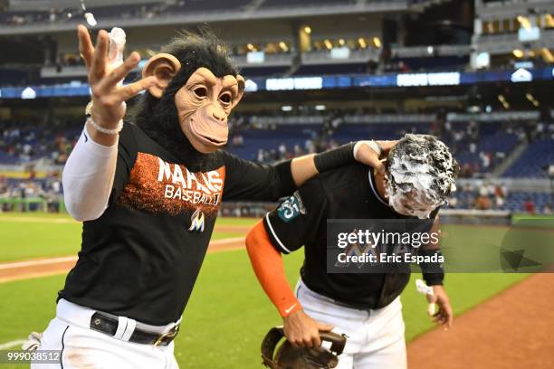 Miguel Rojas of the Miami Marlins puts shaving cream in the face of Martin Prado after defeating the Philadelphia Phillies at Marlins Park on July...