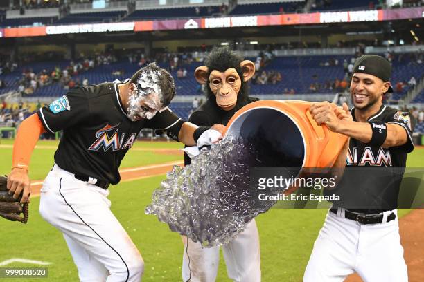 Miguel Rojas of the Miami Marlins and Yadiel Rivera attempt to pour gatorade on Martin Prado after defeating the Philadelphia Phillies at Marlins...