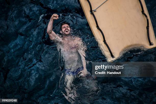 In this handout image provided by Red Bull, David Colturi of the USA celebrates after diving from the 27 metre platform on Islet Vila Franco do Campo...