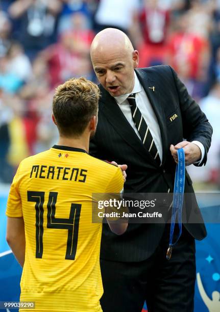 President Gianni Infantino gives a medal to Dries Mertens of Belgium during the medal ceremony for 3rd place following the 2018 FIFA World Cup Russia...