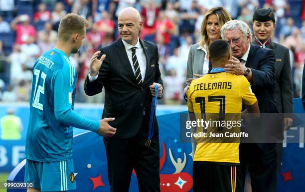 President Gianni Infantino and President of Royal Belgian Football Association Gerard Linard give medals to goalkeeper of Belgium Simon Mignolet,...