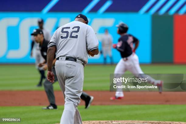 New York Yankees starting pitcher CC Sabathia hangs his head as Cleveland Indians third baseman Jose Ramirez rounds the bases after hitting a home...