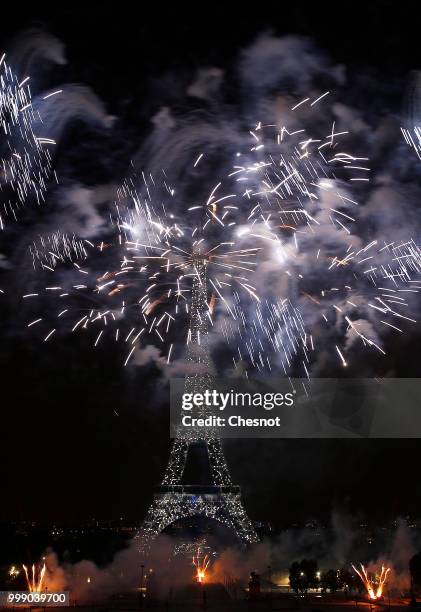 Fireworks burst around the Eiffel Tower as part of Bastille Day celebrations on July 14, 2018 in Paris, France. The theme of the fireworks of this...