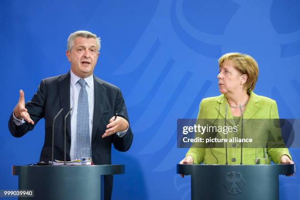 United Nations High Commissioner for Refugees, Filippo Grandi and German Chancellor Angela Merkel answer questions during a press conference...