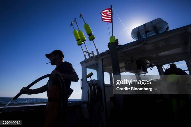 Fisherman hoses down a boat off the coast of Plymouth, Massachusetts, U.S., on Tuesday, July 10, 2018. The proposed tariffs between the U.S. And the...