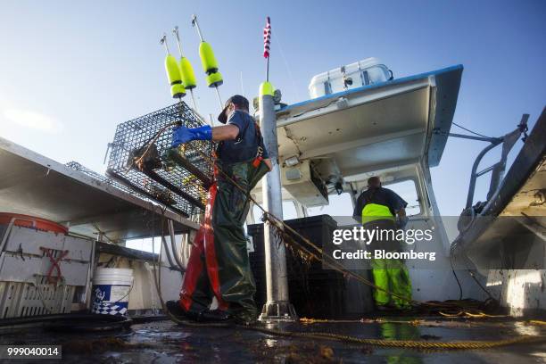 Fisherman moves a steel lobster trap on a boat off the coast of Plymouth, Massachusetts, U.S., on Tuesday, July 10, 2018. The proposed...