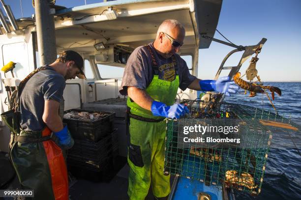 Fishermen inspect the catch in a steel lobster trap on a boat off the coast of Plymouth, Massachusetts, U.S., on Tuesday, July 10, 2018. The proposed...