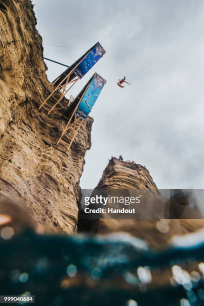 In this handout image provided by Red Bull, Lysanne Richard of Canada dives from the 21 metre platform on Islet Vila Franco do Campo during the final...
