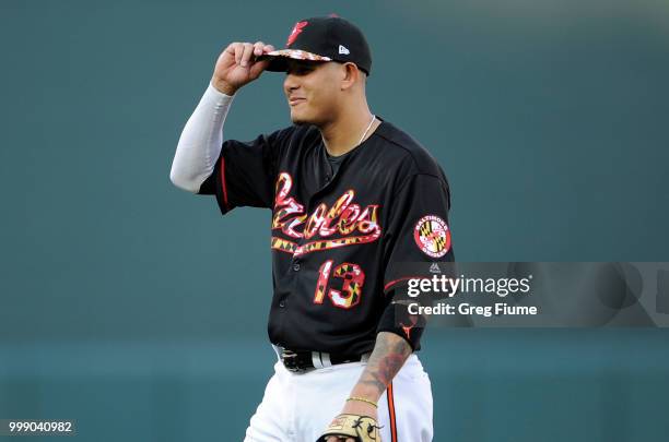 Manny Machado of the Baltimore Orioles warms up before the game against the Texas Rangers at Oriole Park at Camden Yards on July 14, 2018 in...