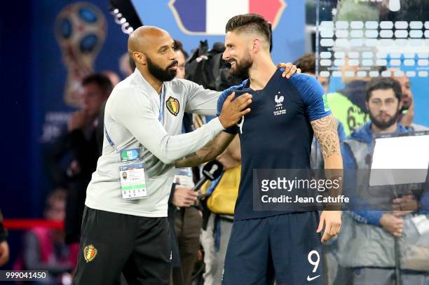 Assistant coach of Belgium Thierry Henry greets Olivier Giroud of France following the 2018 FIFA World Cup Russia Semi Final match between France and...