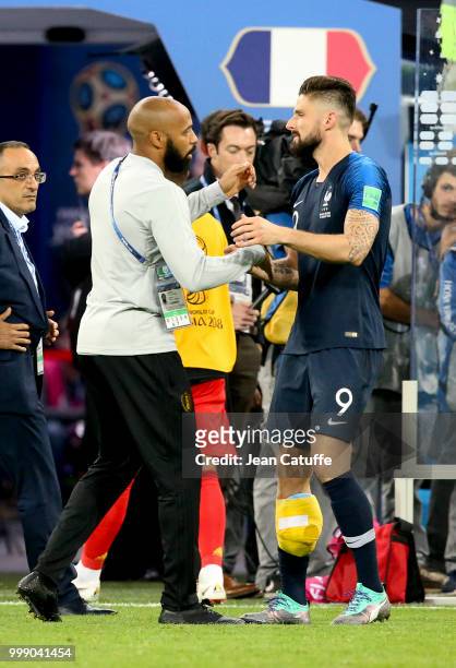 Assistant coach of Belgium Thierry Henry greets Olivier Giroud of France following the 2018 FIFA World Cup Russia Semi Final match between France and...