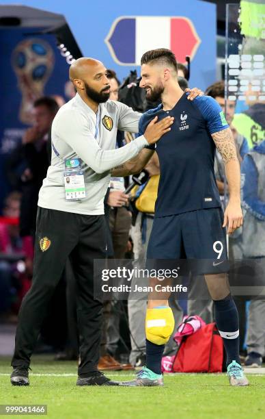 Assistant coach of Belgium Thierry Henry greets Olivier Giroud of France following the 2018 FIFA World Cup Russia Semi Final match between France and...