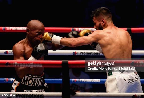 Moruti Mithalane of South Africa fight with Muhammad Waseem of Pakistan during their IBF World boxing championship title bout in Kuala Lumpur,...