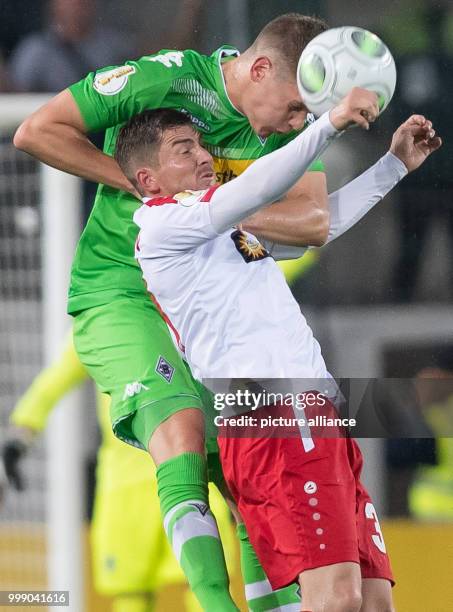 Gladbach's Matthias Ginter ad Essen's Benjamin Baier vie for the ball during the DFB-Cup's first round soccer match between Rot-Weiss Essen and...