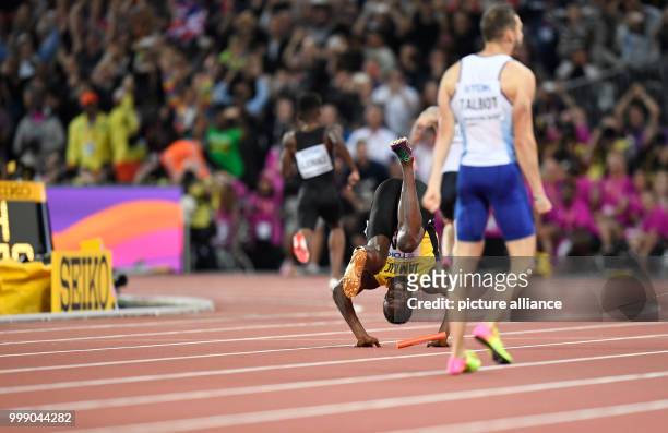 Jamaican athlete Usain Bolt tumbles head over heels after suffering an injury while competing in the men's 4 x 100 metre relay race at the IAAF World...