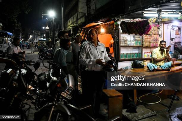 This photo taken on June 2, 2018 shows Bahadur Choudhary a fourth-generation caretaker of Varanasi's ancient cremation grounds, sitting at his house...