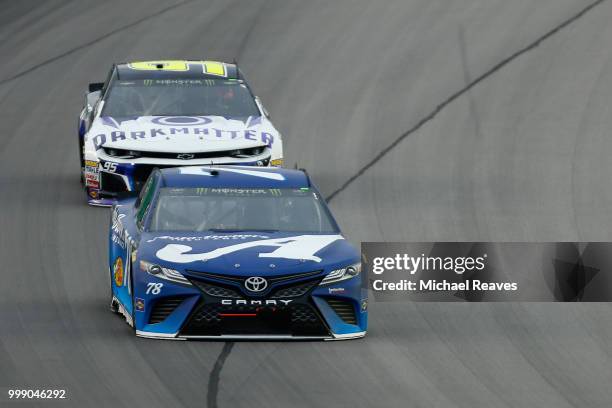 Martin Truex Jr., driver of the Auto-Owners Insurance Toyota, leads Kasey Kahne, driver of the Dark Matter presented by Ionomy Chevrolet, during the...