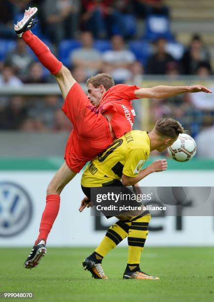 Rielasingen's Robin Niedhardt and Dortmund's Felix Passlack vie for the ball during the German Soccer Association Cup first-round soccer match...