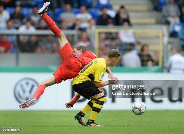 Rielasingen's Robin Niedhardt and Dortmund's Felix Passlack vie for the ball during the German Soccer Association Cup first-round soccer match...