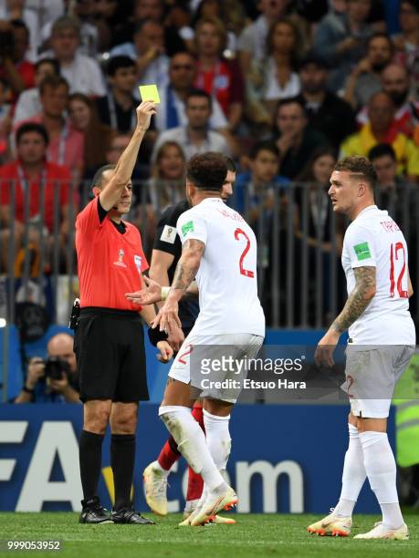 Referee Cuneyt Cakir of Turkey shows an yellow card to Kyle Walker of England during the 2018 FIFA World Cup Russia Semi Final match between England...