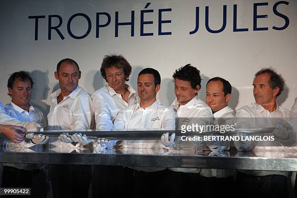 French skipper Franck Cammas and his teammates carry the Jules Verne Trophy, on May 18, 2010 during the award ceremony held at the National Marine...