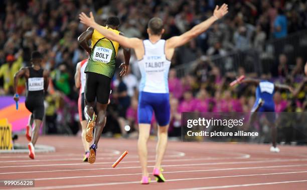 Jamaican athlete Usain Bolt leaves the track after suffering an injury while competing in the men's 4 x 100 metre relay race at the IAAF World...