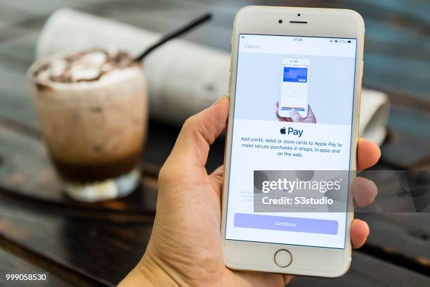 Man holds a smart phone with Apple Pay application is displayed on July 13 2018 in Hong Kong, Hong Kong.