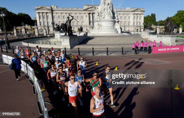 Competitors in the 50 kilometre marathon at the IAAF London 2017 World Athletics Championships run past Buckingham Palace in London, United Kingdom,...