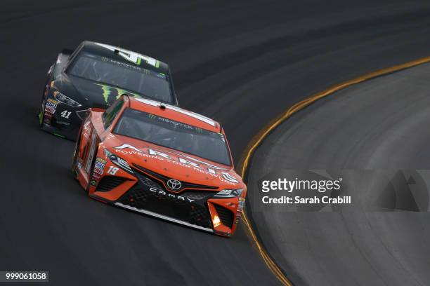 Daniel Suarez, driver of the ARRIS Toyota, leads Kurt Busch, driver of the Monster Energy/Haas Automation Ford, during the Monster Energy NASCAR Cup...