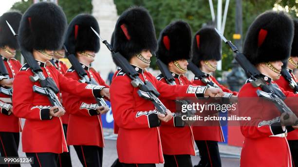 Members of the Queen's Guard cross The Mall during the 50 kilometre marathon event at the IAAF London 2017 World Athletics Championships in London,...