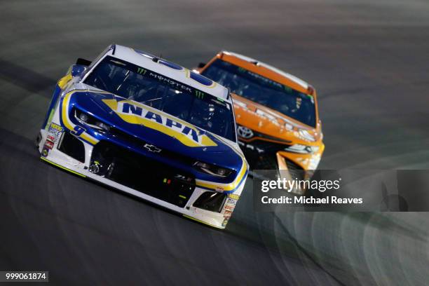 Chase Elliott, driver of the NAPA Auto Parts Chevrolet, leads Daniel Suarez, driver of the ARRIS Toyota, during the Monster Energy NASCAR Cup Series...