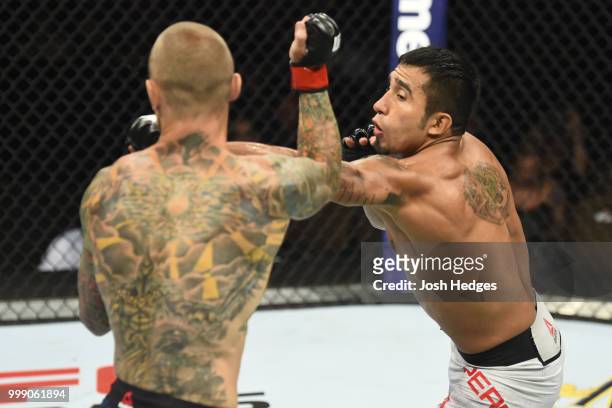 Alejandro Perez of Mexico punches Eddie Wineland in their bantamweight fight during the UFC Fight Night event inside CenturyLink Arena on July 14,...